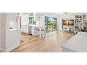 Bright, open-concept living room featuring wood floors, barstool seating and sliding doors to the outside at 1917 Iowa Ne Ave, St Petersburg, FL 33703