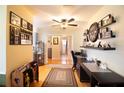 Inviting hallway featuring hardwood floors, decorative shelving, and a view into the living area at 2010 6Th Sw Ave, Largo, FL 33770