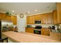Kitchen featuring stainless steel appliances, ample cabinet space, and breakfast bar at 2038 Oswego Dr, Holiday, FL 34691