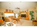Bright living room featuring tile flooring, ceiling fan, and built-in shelving at 2038 Oswego Dr, Holiday, FL 34691