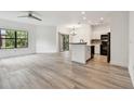 Spacious open-concept living space with modern flooring and white walls at 2171 Portofino Pl # 27-2725, Palm Harbor, FL 34683