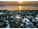 Breathtaking aerial view of the coastal community at sunset, highlighting waterfront access and neighborhood charm at 224 Georgia Ave, Crystal Beach, FL 34681