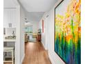 Hallway showcasing the property's updated laminate floors and abundant natural light at 2460 Northside Dr # 802, Clearwater, FL 33761