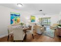 Cozy living room features a dining area, comfortable seating, and sliding glass doors to an enclosed patio at 2460 Northside Dr # 802, Clearwater, FL 33761