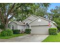 Attractive home with a lush lawn, manicured bushes, and a two-car garage at 3101 Beaver Pond Trl, Valrico, FL 33596