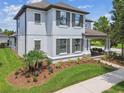 View of home from the side, showcasing landscaping and covered front porch with porch swing at 3257 Heart Pine Ave, Odessa, FL 33556