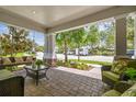 Inviting covered front porch featuring comfortable seating, stone accents, and a landscaped view at 3257 Heart Pine Ave, Odessa, FL 33556