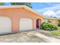 Front exterior of a single-story home with a two-car garage and a red front door at 358 Suwanee Ave, Sarasota, FL 34243