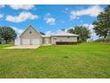 Lovely home with an attached two-car garage and a well-kept green lawn at 39905 Townsend Rd, Dade City, FL 33525