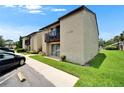 Condo building featuring well-kept landscaping, multiple units, and parking area in a desirable neighborhood at 4215 E Bay Dr # 1801E, Clearwater, FL 33764