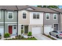 Modern townhome boasts a clean facade, attached garage, and well-maintained landscaping at 4338 Banjo Lake Rd, Land O Lakes, FL 34639