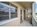 Condo balcony with concrete floor, decorative blocks, screen door and view of the outdoors at 5720 13Th N Ave # 207B, St Petersburg, FL 33710