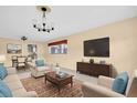 Living room boasts comfortable furniture, neutral colors, and natural light from the window at 5720 13Th N Ave # 207B, St Petersburg, FL 33710