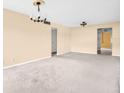 Empty living room featuring carpet, neutral paint and lighting overhead at 5720 13Th N Ave # 207B, St Petersburg, FL 33710
