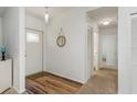 Inviting entryway with wood-look floors, coat closet, and attractive mirror accent at 630 Kirkland Cir, Dunedin, FL 34698