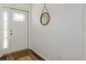 Bright entryway featuring wood flooring, a stylish mirror, and a well-lit, welcoming space at 630 Kirkland Cir, Dunedin, FL 34698