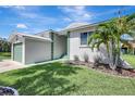 Single-story home features manicured lawn and mature palm trees creating a serene outdoor space at 6603 S Juanita St, Tampa, FL 33616