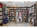 Custom walk-in closet with ample storage space and shelving for shoes and clothing at 7570 Sweeter Tide Trl, Wesley Chapel, FL 33545
