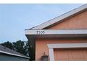 Close-up of house address numbering, 7105, and showing trim detail on home exterior at 7705 Nottinghill Sky Dr, Apollo Beach, FL 33572