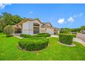 Attractive single-story home with vibrant landscaping and a well-manicured lawn at 9751 Conservation Dr, New Port Richey, FL 34655