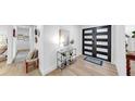 Bright foyer featuring modern double doors, stylish decor, and wood-look tile flooring at 9903 Saddle Rd, Tampa, FL 33626