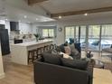 Open-concept living area with modern kitchen, large island, and seamless access to a screened-in outdoor pool at 9903 Saddle Rd, Tampa, FL 33626