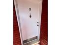 Condo front door with unit number, classic knocker, and secure lock, providing a welcoming entry at 1025 82Nd N Ter # 1025D, St Petersburg, FL 33702