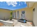 Inviting front entrance with decorative wreath, beautiful accents, and pleasant landscaping at 1270 Inverness, Dunedin, FL 34698