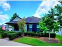 Attractive single-story house with well-maintained lawn, charming landscaping, and American flag at 12862 Rangeland Blvd, Odessa, FL 33556