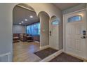 Inviting entryway with a decorative mirror, a front door with glass accents, and wood-look tile flooring at 13029 111Th Ln, Largo, FL 33778