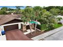 Charming home featuring a two-car garage, private pool, and beautiful mature trees at 13501 Avista Dr, Tampa, FL 33624