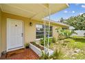 Inviting front porch with terracotta tile and a decorative planter, enhancing curb appeal at 1707 Cardinal Dr, Clearwater, FL 33759
