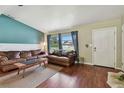 Comfortable living room featuring hardwood floors, large windows, and neutral paint at 1707 Cardinal Dr, Clearwater, FL 33759