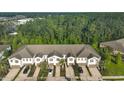 A high angle view of modern townhomes surrounded by a dense forest canopy at 17834 Althea Blue Pl, Lutz, FL 33558