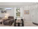 Open dining area featuring a modern table set, pendant lighting, and stylish decor next to the living room at 2032 Inverness Greens Dr # 76, Sun City Center, FL 33573