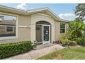 Inviting entryway featuring a decorative storm door, tiled archway, and well-manicured landscaping at 2032 Inverness Greens Dr # 76, Sun City Center, FL 33573