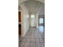 Inviting entryway with tile flooring, high ceilings, and arched doorways, offering a warm welcome at 221 Fairmont Dr, Spring Hill, FL 34609