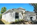 Charming single-Gathering home with a well-maintained stucco exterior and beautiful landscaping at 221 Fairmont Dr, Spring Hill, FL 34609