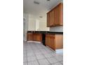 Well-lit kitchen with spacious tile floors and wood cabinets, providing practical storage solutions at 221 Fairmont Dr, Spring Hill, FL 34609