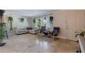Spacious living room featuring neutral walls, tiled floors, comfortable seating, and natural light at 2525 W Bay Dr # B43, Belleair Bluffs, FL 33770