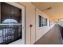 Exterior walkway featuring unit entrances, neutral tones, and an open-air design with an iron railing at 2525 W Bay Dr # B43, Belleair Bluffs, FL 33770