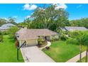 Charming single-Gathering home with a well-kept lawn, circular driveway, and mature trees offering shade and privacy at 2806 Fairway View Dr, Valrico, FL 33596