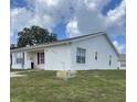 View of a single-story villa exterior with white siding, red shutters and well maintained lawn at 3007 Wainwright Ct, New Port Richey, FL 34655