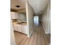 Open living space featuring updated flooring, a kitchen with modern appliances and living area at 3007 Wainwright Ct, New Port Richey, FL 34655