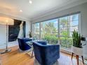 Bright living room with hardwood floors, large windows, and stylish blue armchairs at 301 23Rd Ne Ave, St Petersburg, FL 33704