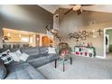 Spacious living room with spiral staircase, vaulted ceilings, and carpet flooring at 3127 W Sligh Ave # 303B, Tampa, FL 33614