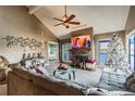 Cozy living room featuring a fireplace, television, large sectional sofa, and Christmas decorations at 3127 W Sligh Ave # 303B, Tampa, FL 33614