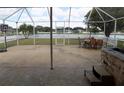 Outdoor living on a screened patio including a hot tub, dining, and lake views at 3512 Osprey Cove Dr, Riverview, FL 33578