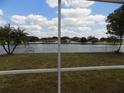 Picture perfect view of a tranquil lake from the backyard through the screened in porch at 3512 Osprey Cove Dr, Riverview, FL 33578