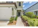 Inviting entryway with a walkway framed by lush greenery and a charming front door at 36414 Well Hill Way, Zephyrhills, FL 33541